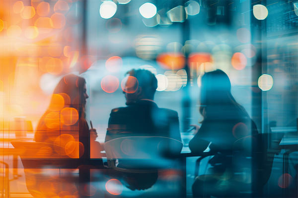 small group office meeting seen through an office window, engaging discussion, trendy blur style