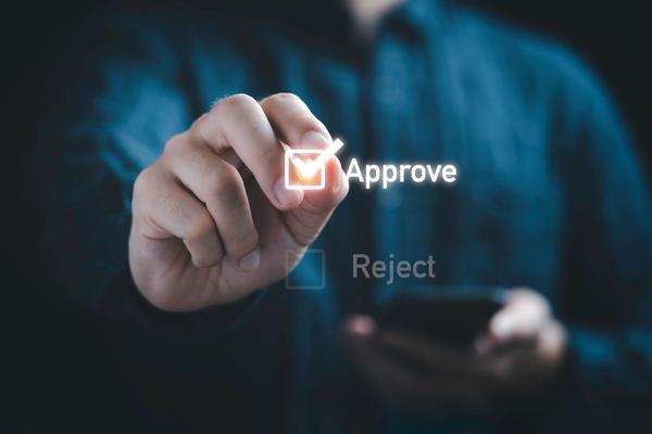 Man holding the word approve in his hand